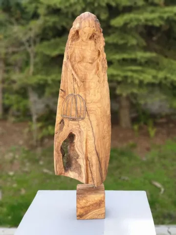 "Tutsak" eseri HAKAN ERASLAN tarafından 2018 yılında 71x21x16 cm ölçülerinde Zeytin Ağacı Yontu tekniği ile yapılmıştır.